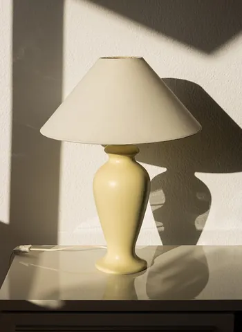 lampshade: a cover over a lamp to either diffuse the light or to block it in certain directions to avoid glare...