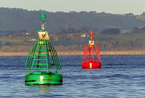 lateral mark: a buoy or other navigational mark denoting the port or starboard edge of a channel