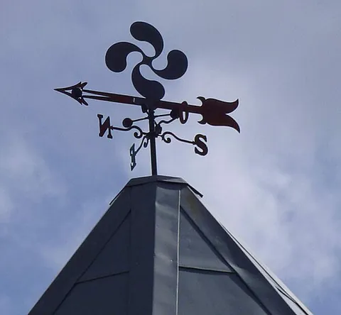 lauburu: a traditional Basque symbol consisting of four comma-shaped arms arranged in a cross, resembling a...