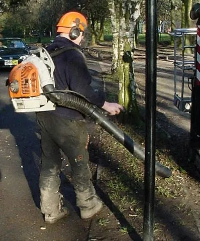 leaf blower: a motorized garden tool that propels air out of a nozzle to move leaves and other debris