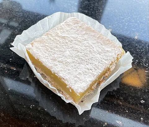 lemon bar: a square or rectangular dessert consisting of a thin shortbread crust and lemon curd filling