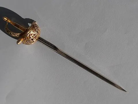 letter opener: a device shaped like a fixed-blade knife, usually with a blunt edge; the blunt edge does not slice...