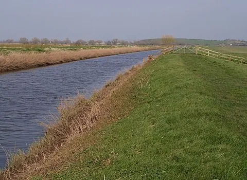 levee: an elevated ridge of deposited sediment on the banks of a river, formed by the river's overflow at...