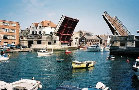 lifting bridge: a type of movable bridge over a body of water with one or two spans that can be raised to allow the...