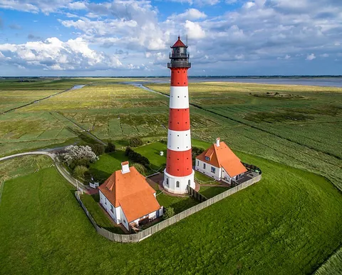 lighthouse: a tower or other structure exhibiting a light or lights to warn or guide sailors