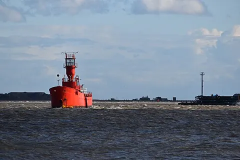 lightship: a ship riding at anchor and displaying a light for the guidance of sailors, in a position where a...