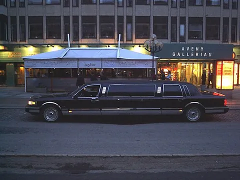 limousine: an automobile body with seats and permanent top like a coupe, and with the top projecting over the...