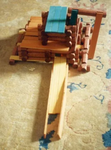 lincoln logs: a construction toy consisting of miniature, notched logs from which log cabins and similar...