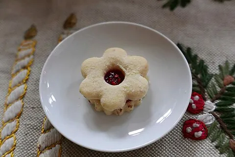 linzer cookie: a sandwich cookie version of the Linzertorte, topped with a layer of dough with a circular cut-out...