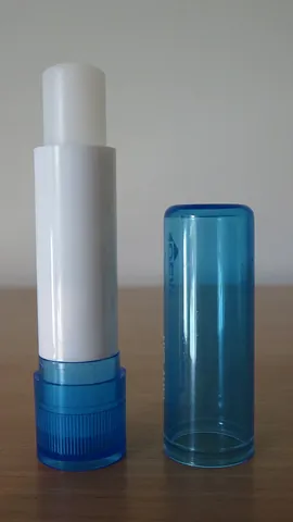 lip balm: a substance topically applied to the lips of the mouth to relieve chapped or dry lips, angular...