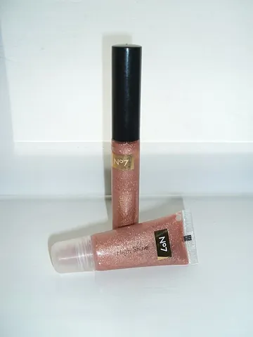 lip gloss: a cosmetic product applied to the lips to make them look shinier