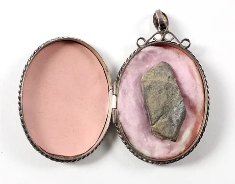 locket: a pendant that opens to reveal a space used for storing a photograph or other small item