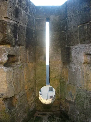 loophole: a slit in a castle wall; today, any similar window for shooting a ranged weapon or letting in light