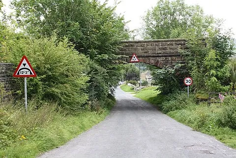 low bridge: usually any bridge over a roadway under which vehicles above a certain height cannot pass, as well...