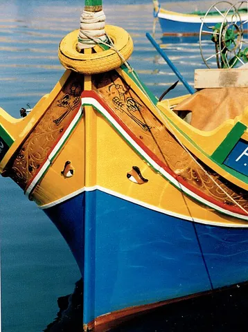 luzzu: a traditional brightly-painted Maltese fishing boat, characteristically adorned with a pair of eye...
