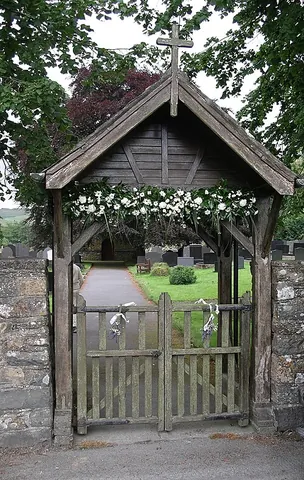 lych-gate: a churchyard gateway with a roof, under which a corpse was laid during a funeral to await the...