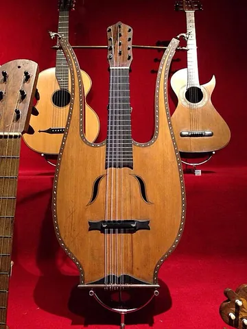 lyre-guitar: a type of guitar shaped to look like a lyre, popular as a fad instrument in the late 1800s