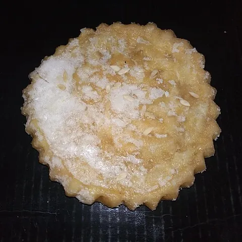 maath: a kind of large, thick and sweet fried puri coated with sugar syrup