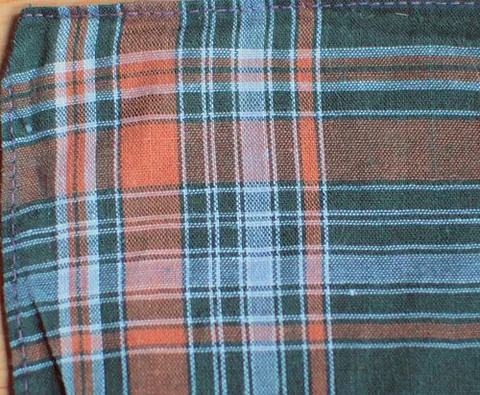 madras: a brightly colored cotton fabric with a checked or striped pattern