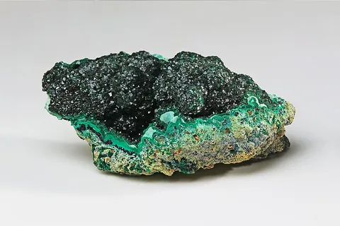 malachite: a bright green mineral, a basic copper carbonate, Cu₂CO₃(OH)₂; one of the principal ores of copper