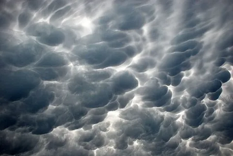 mammatus cloud: a cellular pattern of pouches hanging underneath the base of a cloud