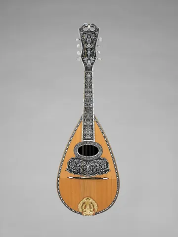 mandolin: a stringed instrument of the lute family, having eight strings in four courses, frequently tuned as...