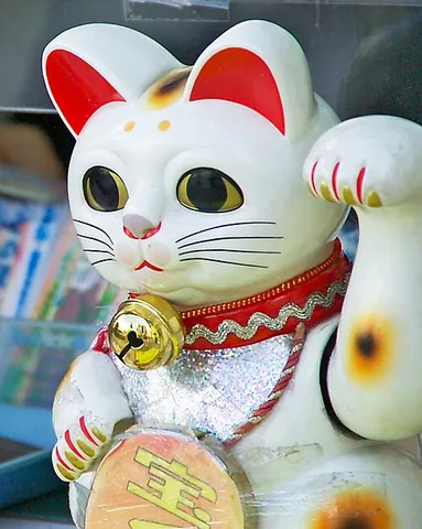 maneki-neko: a common Japanese figurine which is often believed to bring good luck to the owner