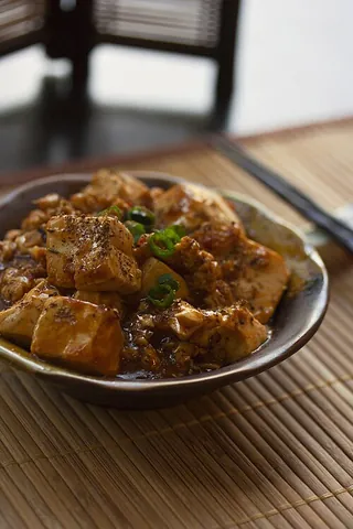 mapo doufu: a Chinese dish from Sichuan province consisting of tofu set in a spicy chili- and bean-based sauce,...