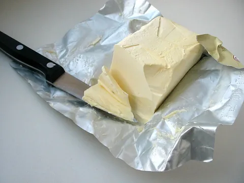 margarine: a spread, manufactured from a blend of vegetable oils (some of which are hydrogenated), emulsifiers...