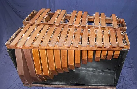 marimba: a percussion instrument with African origins, similar to a xylophone with resonators, but much...