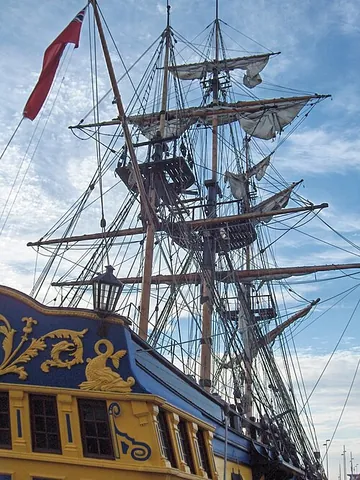 mast: a tall, slim post or tower, usually tapering upward, used to support, for example, sails or...