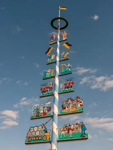 maypole: a pole, garlanded with streamers held by people who dance around it to celebrate May Day