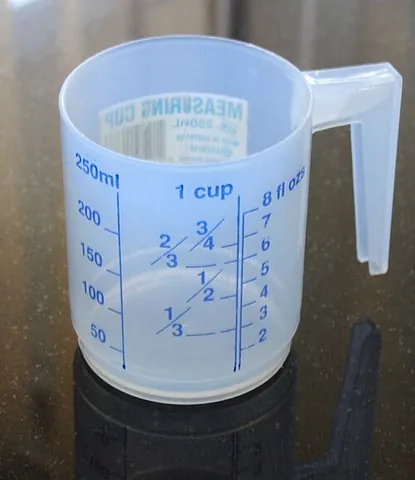 measuring cup: a kitchen utensil used primarily to measure the volume of liquid or bulk solid cooking ingredients