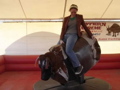 mechanical bull: an amusement ride consisting of a device that replicates the sensation of riding a bucking animal,...