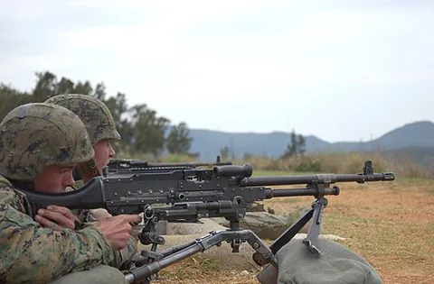 medium machine gun: a belt-fed machine gun firing a full-powered rifle cartridge, and is considered “medium” in weight...