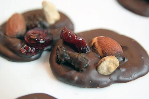 mendiant: a traditional French Christmas confection, a chocolate disc studded with nuts and dried fruits...