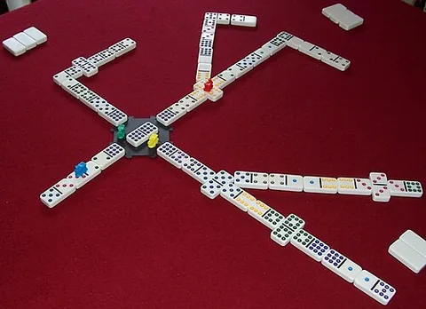 mexican train: a game played with numbered dominoes, in which each player attempts to play all of his/her dominoes...