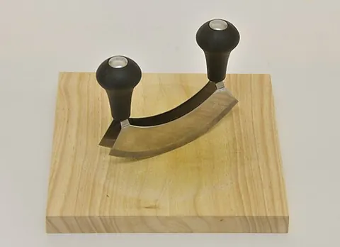 mezzaluna: a crescent-shaped steel blade attached to a wooden handle, used to chop food