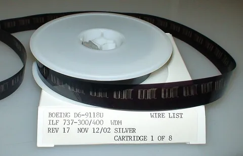 microfilm: a continuous roll of film containing photographs of documents at a greatly reduced size