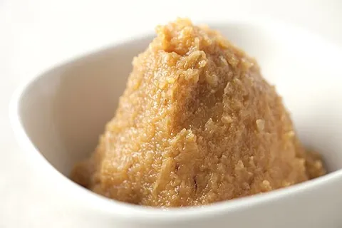 miso: a thick paste made by fermentation of soybeans with the mold Aspergillus oryzae, used in making...