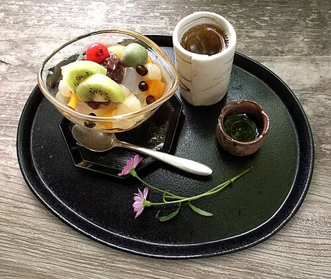 mitsumame: a Japanese dessert made of small cubes of agar jelly, served in a bowl with boiled red field peas...