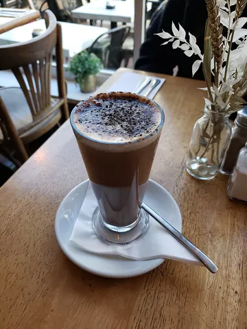 mocha: a coffee drink with chocolate syrup added, or a serving thereof