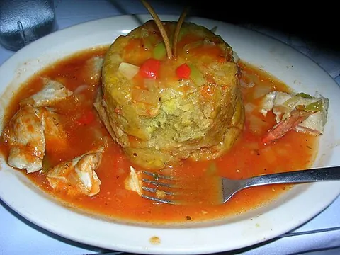 mofongo: a Caribbean dish of fried green plantains or yuca seasoned with garlic, olive oil and pork...