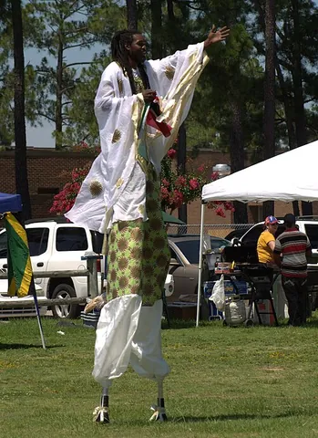 moko jumbie: a carnival performer in the Caribbean who walks or dances on stilts