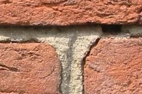 mortar: a mixture of lime or cement, sand and water used for bonding building blocks