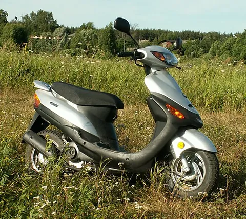 motor scooter: a small motorcycle or moped with a step-through frame