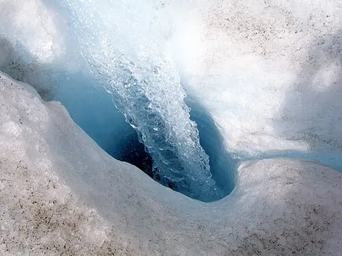 moulin: a cylindrical, vertical shaft that extends through a glacier and is carved by meltwater from the...