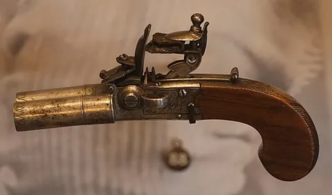 muff pistol: a small flintlock or percussion gun, usually for women, which can be hidden in a muff (hand-warmer)