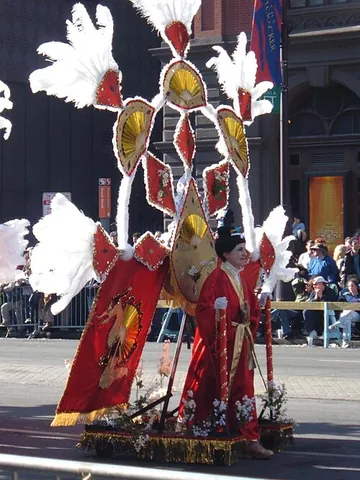 mummer: a person who dons a disguising costume, as for a parade or a festival