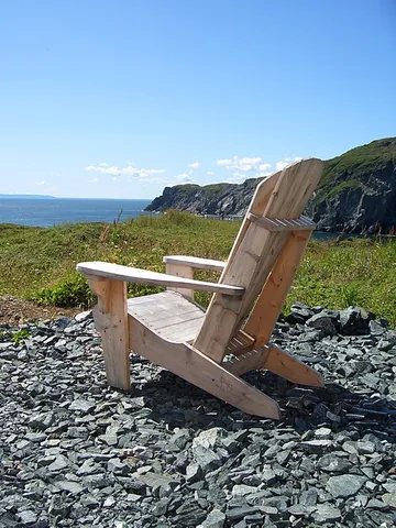 muskoka chair: a kind of outdoor lounge chair made of wood, with wide arm rests; Adirondack chair